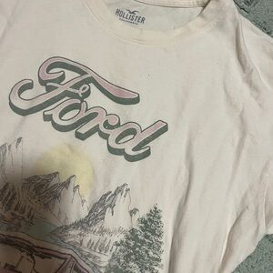 Hollister Cream Crewneck Tee with Pale Blue Logo